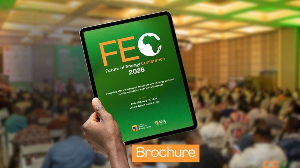 A tablet with FEC 2026 Brocure cover displaying, held in hand, blurred FEC auditorium filled with crowd in background.